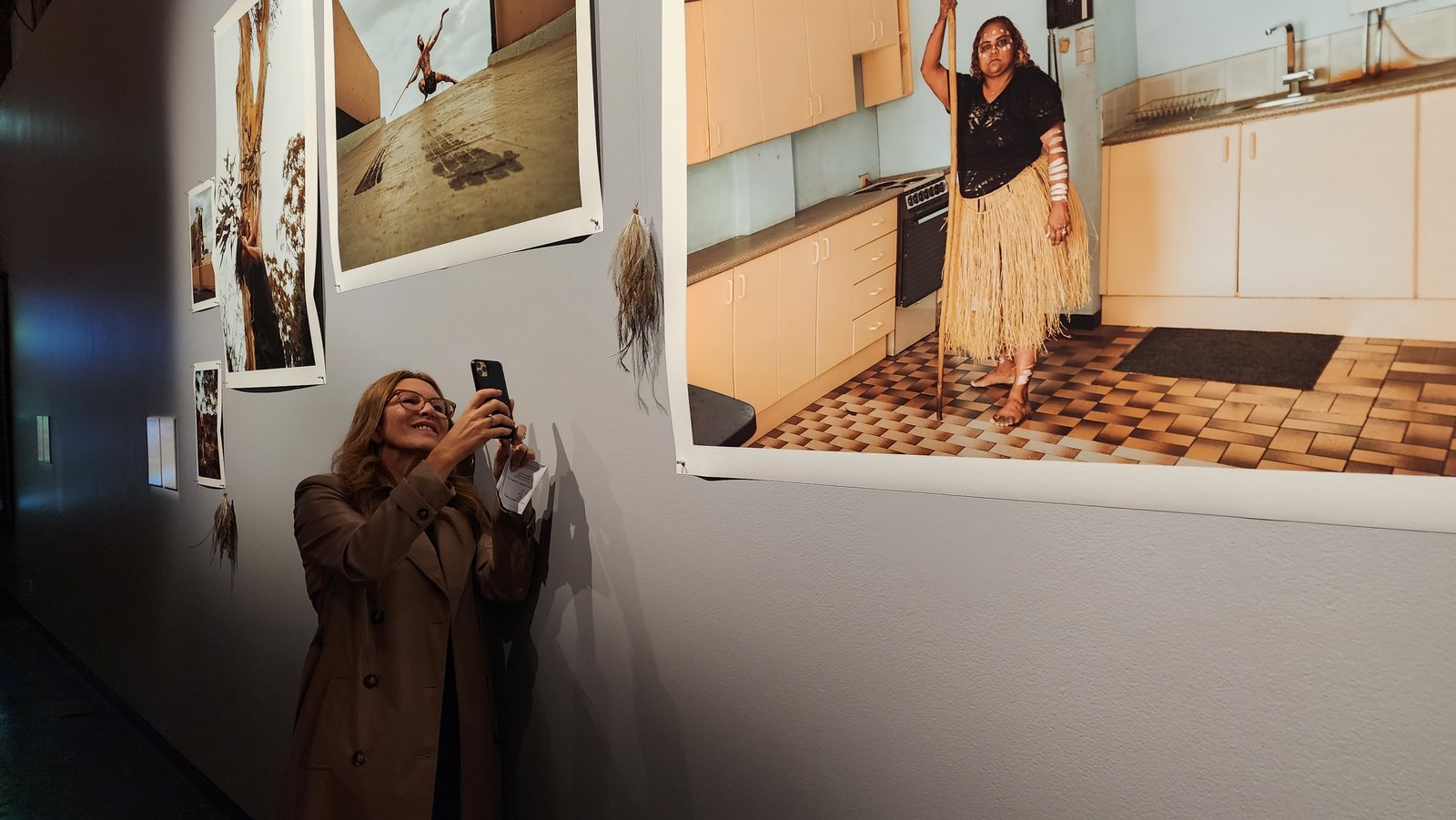 A participant photographing Indigenous artwork during the Casula Powerhouse training day