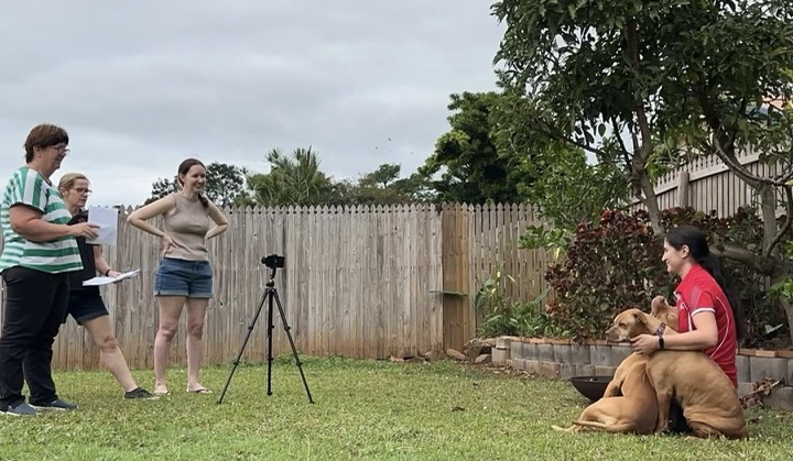 Suzie mentoring a team as they film outdoors
