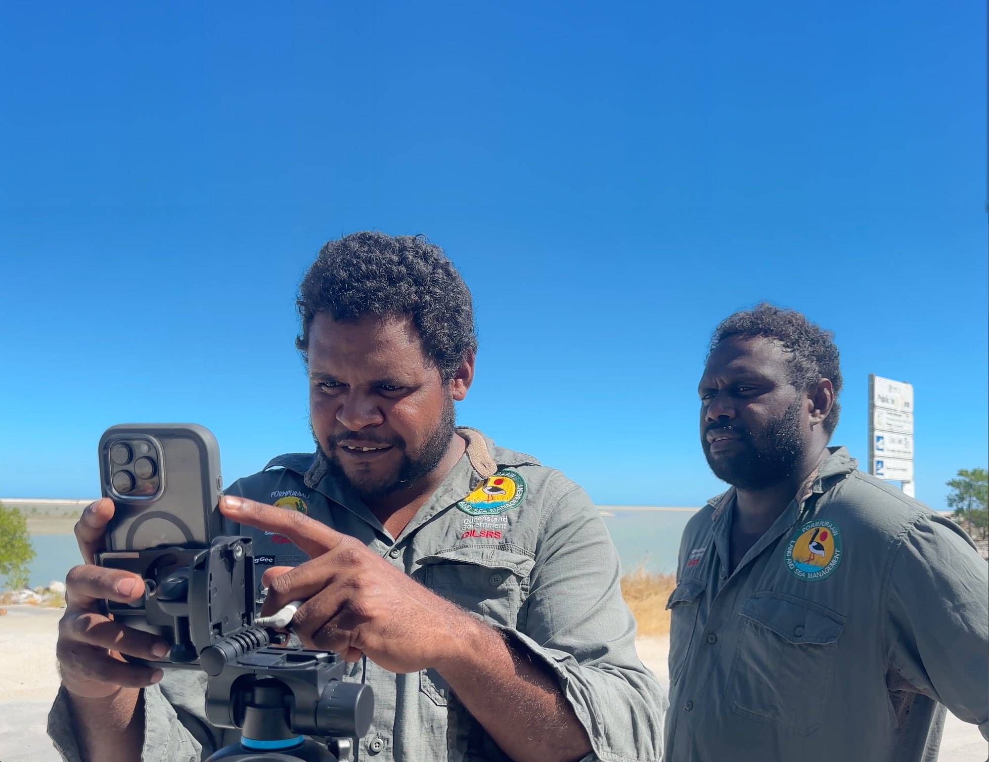Pormpuraaw Land and Sea Rangers filming on Country with a phone