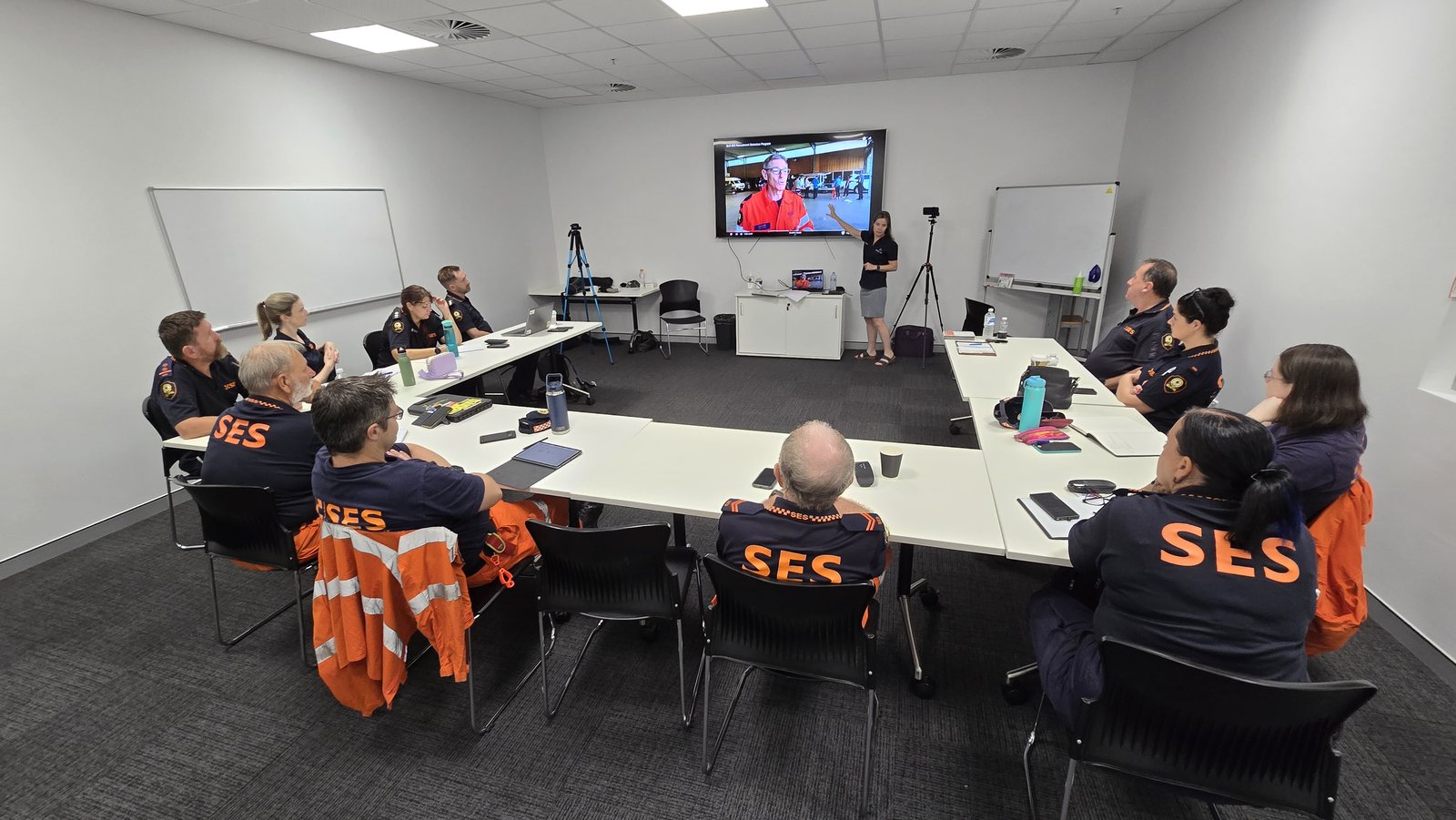 Suzie leading a smartphone video training session with a Townsville SES team